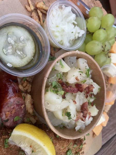 Close-up of German potato salad, sausage, and schnitzel